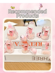 Detail of pink cartoon bear liquid quicksand keychains in various bottle shapes with bells