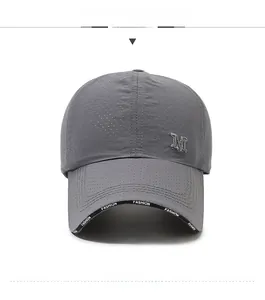 Macro view of grey quick-dry baseball cap featuring breathable mesh and metal M logo