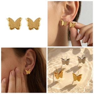 Detail of matte and polished butterfly studs in gold and silver stainless steel finish