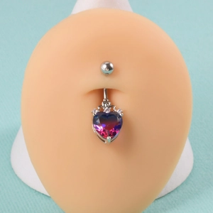 Detail of heart-shaped gradient gem belly button ring with a crown on a display model