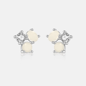 Macro shot of S925 sterling silver studs with creamy opal-like stones and clear cubic zirconia