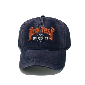 Detail of navy blue washed cotton baseball cap featuring vintage New York 3D embroidery