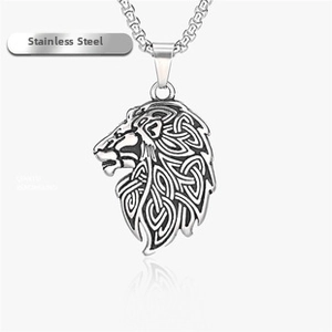 Detailed macro view of lion head pendant with Celtic knot patterns in matte stainless steel