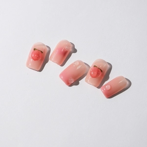Pink peach ombré press-on nails with 3D peach charms and realistic clear water droplets
