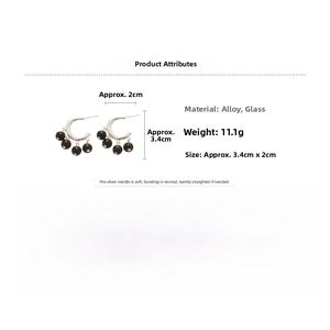 Detailed view of silver C-shaped tassel earrings with black beads and 3.4cm size specs