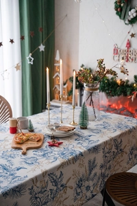 Close-up of vintage blue floral print tablecloth in a warm Christmas dinner setting