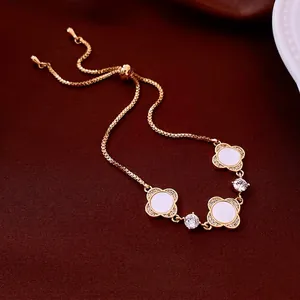 Adjustable 18K gold plated bracelet with white clover charms and sparkling zircon accents