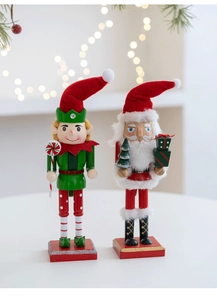 Close-up of hand-painted wooden Nutcracker and Santa ornaments with blurred Christmas lights