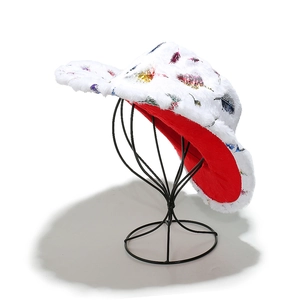 Detail of plush winter bucket hat with colorful feather prints and red faux fur lining