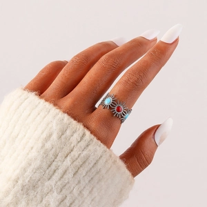 Bohemian stainless steel sunburst ring with red and turquoise stones on hand