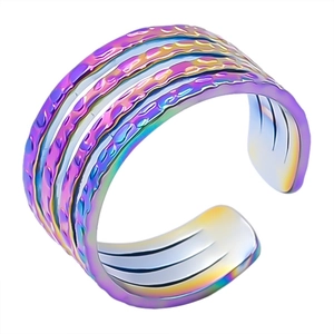 Macro detail of multi-layer rainbow stainless steel open ring with irregular texture