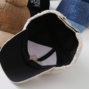 Detailed interior view showing black cotton lining of the teddy fleece baseball cap