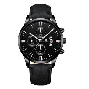 Close-up of black quartz watch face with faux three-eye design and leather strap