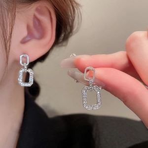 Silver geometric hollow earrings with sparkling diamonds in a minimalist French style