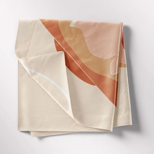 Detail of folded bohemian tapestry with abstract earthy warm geometric patterns