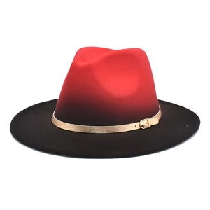 Detailed close-up of a gradient red to black fedora hat with a slim gold metal band