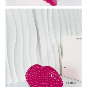 Detail of rose red lip-shaped evening clutch bag with sparkling rhinestones and 15cm height