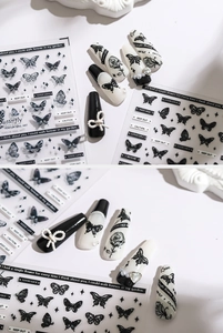 Detail of 3D black butterfly and rose nail stickers on matte press-on nails with pearls