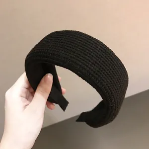 Chic black wide knitted headband for women with a detailed textured braided pattern