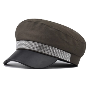 Detail of vintage navy cap with cotton fabric, black leather brim and rhinestone trim