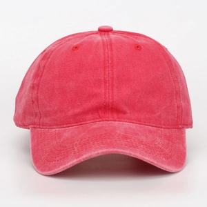 Detail showing a bright pink washed cotton baseball cap with a classic curved brim