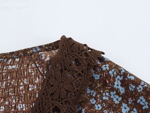 Detail of floral chiffon dress with brown crochet lace trim and smocking texture