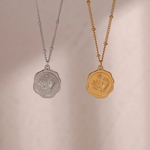 Détails de pendentifs empreinte de bébé en or et argent avec bords ondulés sur chaîne