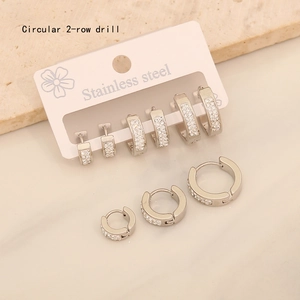 Macro detail of three stainless steel hoop earrings featuring double-row crystal rhinestones