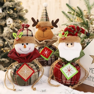 Three Christmas plaid drawstring gift bags featuring Santa, snowman, and reindeer characters