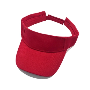 Detail of red cotton sun visor with adjustable velcro strap and twill fabric texture