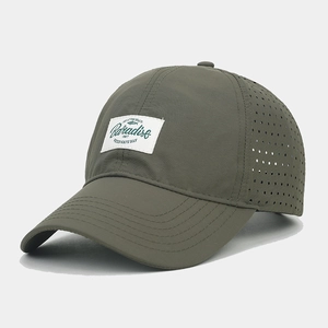 Detail of dark olive green quick-dry baseball cap with breathable laser-cut holes and patch