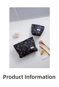 Detail of navy blue floral jacquard makeup bags with gold flowers and makeup tools