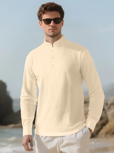 Close-up of cream linen henley shirt with mandarin collar shown in outdoor setting