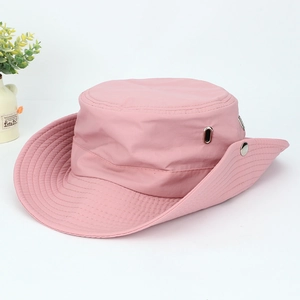 Close-up detail of a pink wide-brimmed western cowboy hat with side snaps and eyelets