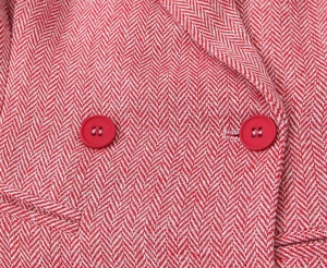Macro shot of red herringbone blazer fabric featuring premium matte finish buttons