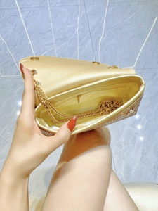 Golden rhinestone shoulder bag with chain strap shown with open interior storage compartment