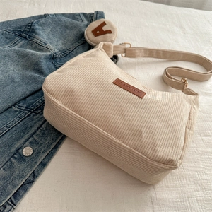 Minimalist beige corduroy tote bag with round A pendant and denim jacket accent