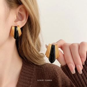 Vintage French geometric black and gold enamel earrings with textured metal frame