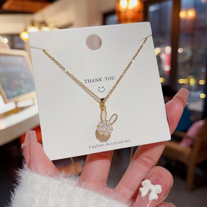 Detailed macro shot of a gold rabbit necklace pendant with sparkling zircon stones