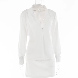 Detail view of white V-neck long sleeve top and high waist mini skirt on mannequin