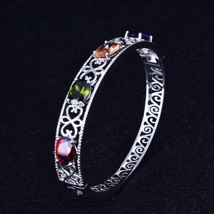 Vintage silver hollow bangle with multi-color gemstones in red green amber blue