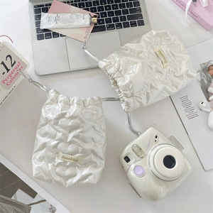 Quilted drawstring storage bags for Polaroid cameras in white heart and bow satin textures