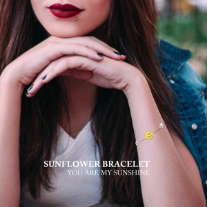 Detail of S925 silver sunflower bracelet with heart charms and a zircon center