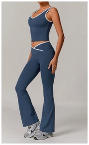 Detail of cross high-waist yoga set with navy contrast piping and backless design