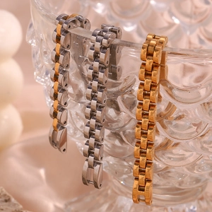 Detailed view of polished stainless steel watch band bracelets in gold silver and two-tone