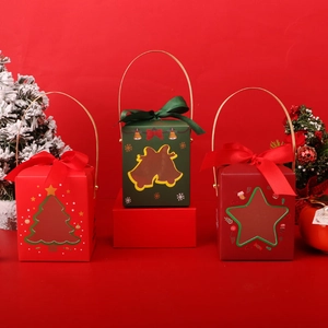 Christmas gift boxes with handles and bow ribbons in red and green for holiday packaging