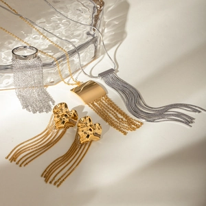 Elegant gold and silver jewelry set featuring tassel necklace and earrings with fringe detail