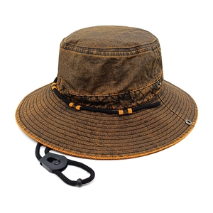 Detailed texture of brown distressed canvas outdoor hat with adjustable windproof cord