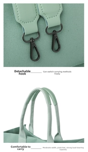 Detail of mint green canvas tote with detachable black metal hooks and durable handles