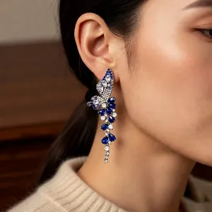 Elegant wing and flower drop earrings with blue crystal tassels and silver needles